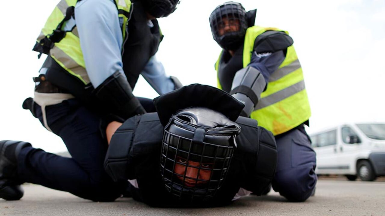 Arab Israeli police recruits detain their colleague during a simulation as part of a training exercise at Israeli police academy center in Beit Shemesh, Israel August 24, 2016. Picture taken August 24, 2016. REUTERS/Ammar Awad - RTX2N06B