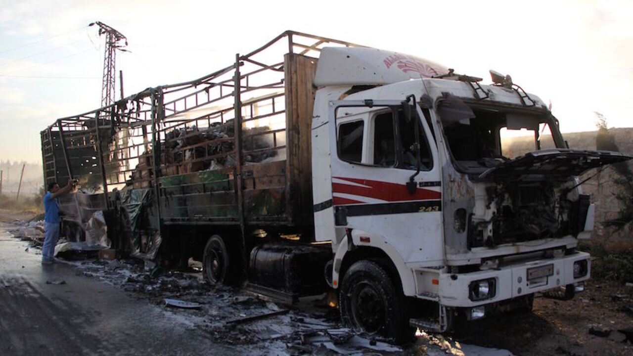 A damaged truck carrying aid is seen on the side of the road in the town of Orum al-Kubra on the western outskirts of the northern Syrian city of Aleppo on September 20, 2016, the morning after a convoy delivering aid was hit by a deadly air strike.
The UN said at least 18 trucks in the 31-vehicle convoy were destroyed en route to deliver humanitarian assistance to the hard-to-reach town.
 / AFP / Omar haj kadour        (Photo credit should read OMAR HAJ KADOUR/AFP/Getty Images)