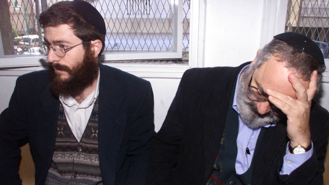 Eli Cohen, (R) and Avihai Weinstein, (L), sit handcuffed at the magistrates court in the Israeli town of Petah Tikva February 2. The court on Wednesday extended the detention of the two Israelis arrested on suspicion of selling large amounts of military equipment to Iran.

HL/FMS - RTRVL3