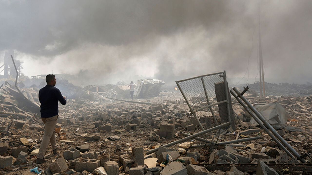 A man walks at a destroyed building at the site of a blast caused by a fire at a weapons storage in eastern Baghdad, Iraq, September 2, 2016. REUTERS/Ahmed Saad - RTX2NV19