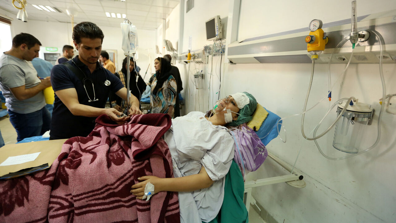 A woman, who was wounded in a bombing at a Kurdish wedding in the northeast Syrian city of Hasaka, lies in a hospital in Dohuk province, Iraq, October 4, 2016.   REUTERS/Ari Jalal  - RTSQP7M