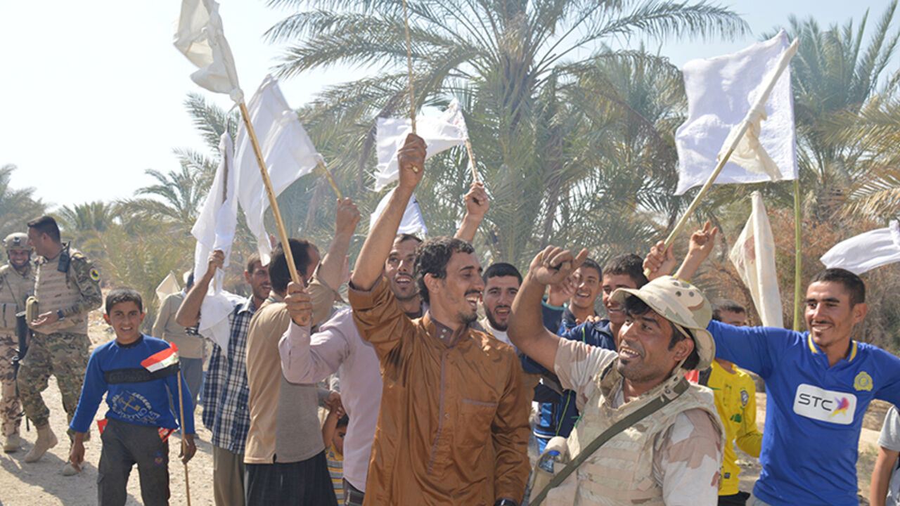 Civilians celebrate with Iraqi army soldiers after returning to their homes in the town of Hit in Anbar province, Iraq October 10, 2016. Picture taken October 10 2016. REUTERS/Stringer - RTSRQ11