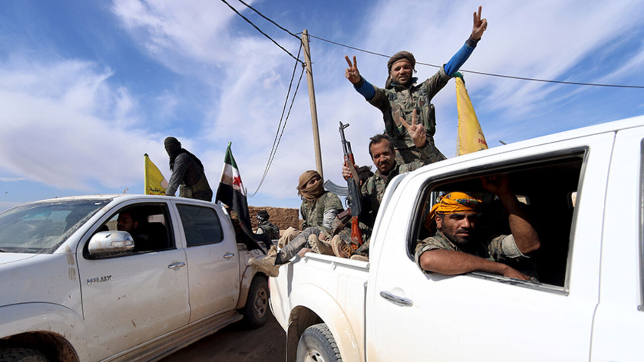 Syria Democratic Forces and Free Syrian Army fighters gesture on the back of pick-up trucks in a village on the outskirts of al-Shadadi town, Hasaka countryside, Syria February 19, 2016. REUTERS/Rodi Said  - RTX27SJG