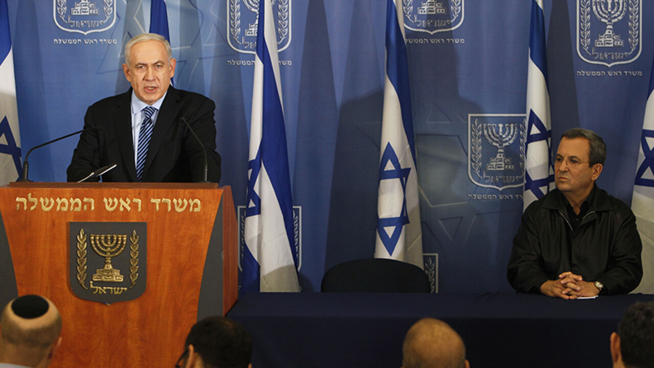 Israel's Defence Minister Ehud Barak (R) sits near Prime Minister Benjamin Netanyahu as he delivers a statement to the media in Tel Aviv November 14, 2012. Israel launched a major offensive against Palestinian militants in Gaza on Wednesday, killing the military commander of Hamas in an air strike and threatening an invasion of the enclave that the Islamist group vowed would "open the gates of hell". REUTERS/Ronen Zvulun (ISRAEL - Tags: POLITICS CIVIL UNREST) - RTR3AEJV