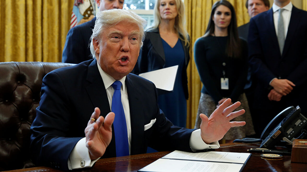 U.S. President Donald Trump speaks to reporters while signing executive orders at the White House in Washington January 24, 2017.  REUTERS/Kevin Lamarque - RTSX5NX
