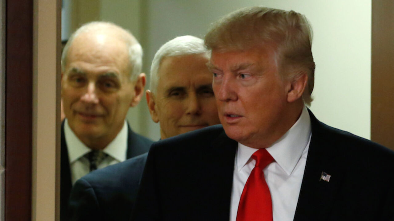 U.S. President Donald Trump (R) and Vice President Mike Pence (C) attend a ceremonial swearing-in for U.S. Homeland Security Secretary John Kelly (L) at Homeland Security headquarters in Washington, U.S., January 25, 2017. REUTERS/Jonathan Ernst - RTSXCQV