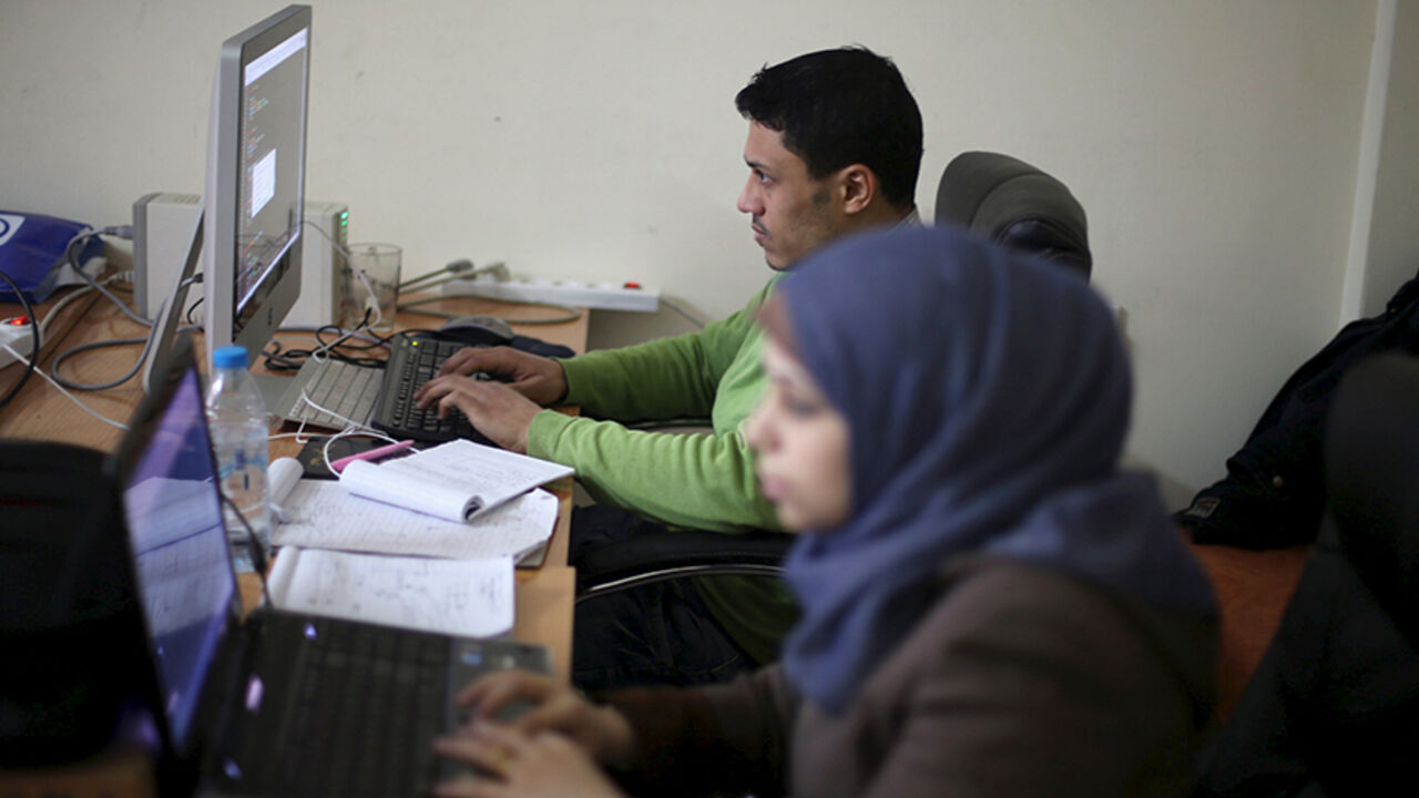 Young Palestinian entrepreneurs use their computers at Gaza Sky Geeks office, in Gaza City January 18, 2016. Picture taken January 18, 2016. REUTERS/Ibraheem Abu Mustafa  - RTX242SL