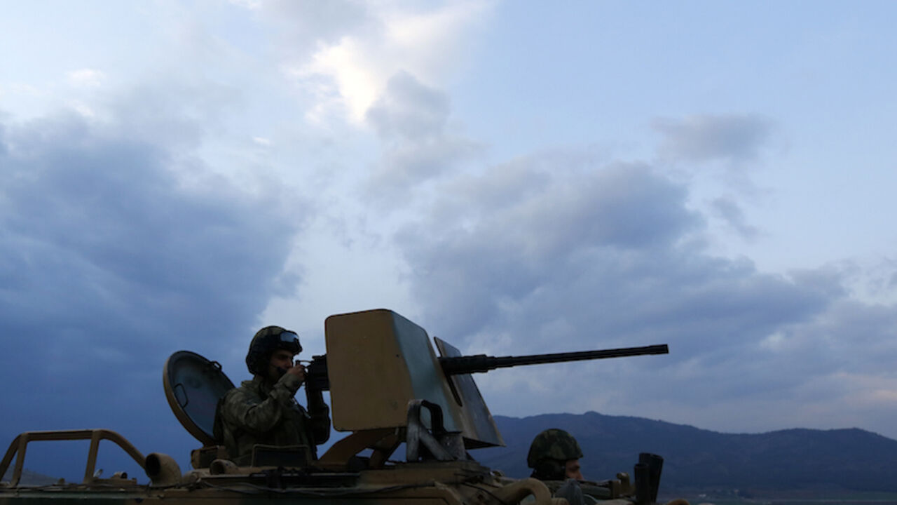 A Turkish soldier on an armoured military vehicle surveys the border line between Turkey and Syria, near the southeastern city of Kilis, Turkey, March 2, 2017. REUTERS/Murad Sezer - RTS115IB