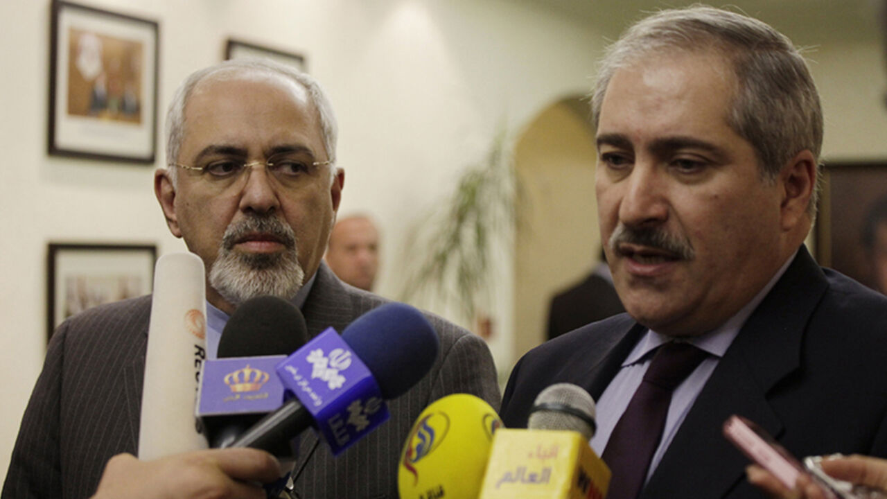 Iranian Foreign Minister Mohammad Javad Zarif (L) listens to his Jordanian counterpart Nasser Judeh during a joint news conference in Amman, Jordan January 14, 2014. REUTERS/Mohammad Hannon/Pool (JORDAN - Tags: POLITICS) - RTX17E5V