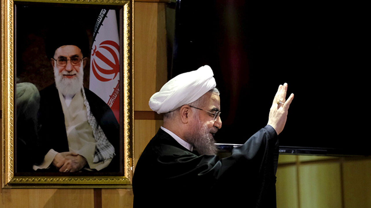 Iranian President Hassan Rouhani waves as he stands next to a portrait of Iran's Supreme Leader Ayatollah Ali Khamenei, after he registered for February's election of the Assembly of Experts, the clerical body that chooses the supreme leader, at Interior Ministry in Tehran December 21, 2015. REUTERS/Raheb Homavandi/TIMA ATTENTION EDITORS - THIS IMAGE WAS PROVIDED BY A THIRD PARTY. FOR EDITORIAL USE ONLY. TPX IMAGES OF THE DAY     - RTX1ZKHQ