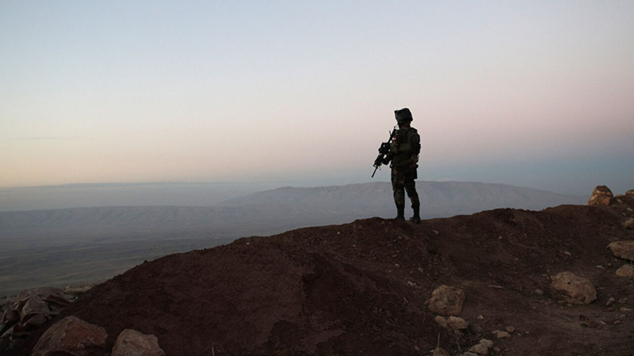 A Kurdish Peshmerga soldier is silhouetted while French President Francois Hollande (not pictured) visits a military outpost on the outskirts of the Islamic State-held city of Mosul, outside the Kurdish city of Erbil, Iraq, January 2, 2017.   REUTERS/Christophe Ena/Pool  - RTX2X9YN
