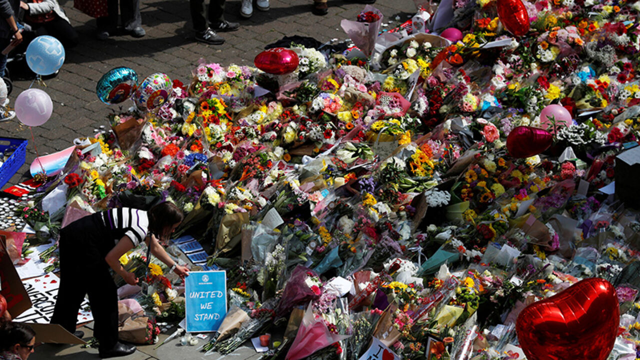 City council employees move flowers from the townhall in Albert Square to St Ann's Square in Manchester, Britain, May 24, 2017. REUTERS/Peter Nicholls - RTX37ERD