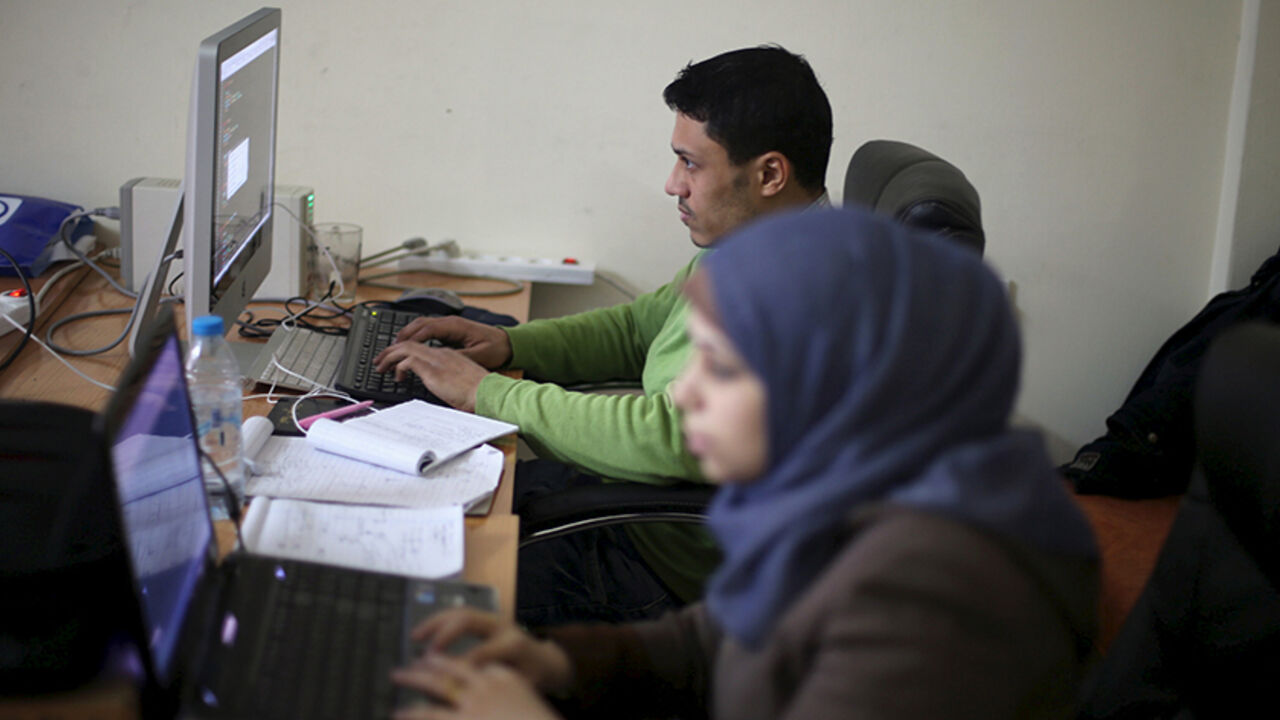 Young Palestinian entrepreneurs use their computers at Gaza Sky Geeks office, in Gaza City January 18, 2016. Picture taken January 18, 2016. REUTERS/Ibraheem Abu Mustafa  - RTX242SL