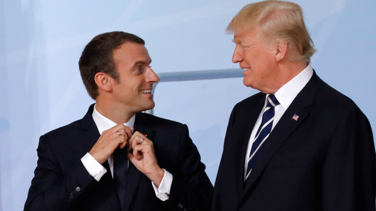U.S. President Donald Trump looks at French President Emmanuel Macron before a family photo at the G20 summit in Hamburg, Germany July 7, 2017.    REUTERS/Carlos Barria - RTX3AGKS