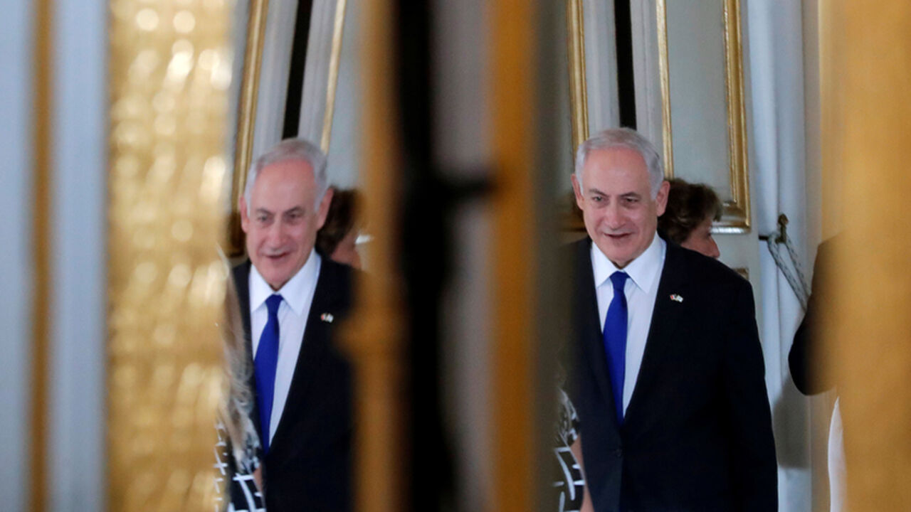 Israeli Prime Minister Benjamin Netanyahu is reflected in a mirror as he attends a joint declaration with French President Emmanuel Macron at the Elysee Palace in Paris, France, July 16, 2017.  REUTERS/Stephane Mahe/Pool - RTX3BO2K