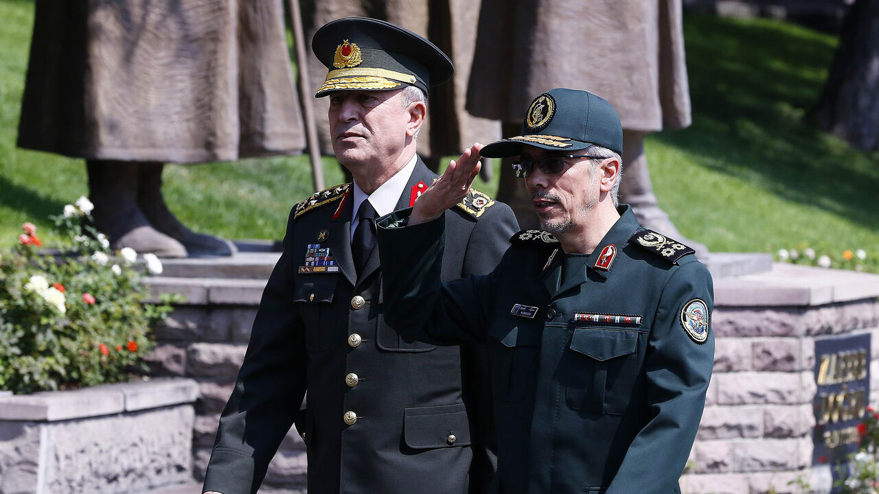 General Staff of the Armed Forces of Iran, Mohammad Bagheri (R) salutes the honor guards as he is welcomed by Chief of the General Staff of the Turkish Armed Forces Hulusi Akar (L) during his official visit at the Turkish General Staff headquarters in Ankara, on August 15, 2017.   / AFP PHOTO / STR        (Photo credit should read STR/AFP/Getty Images)