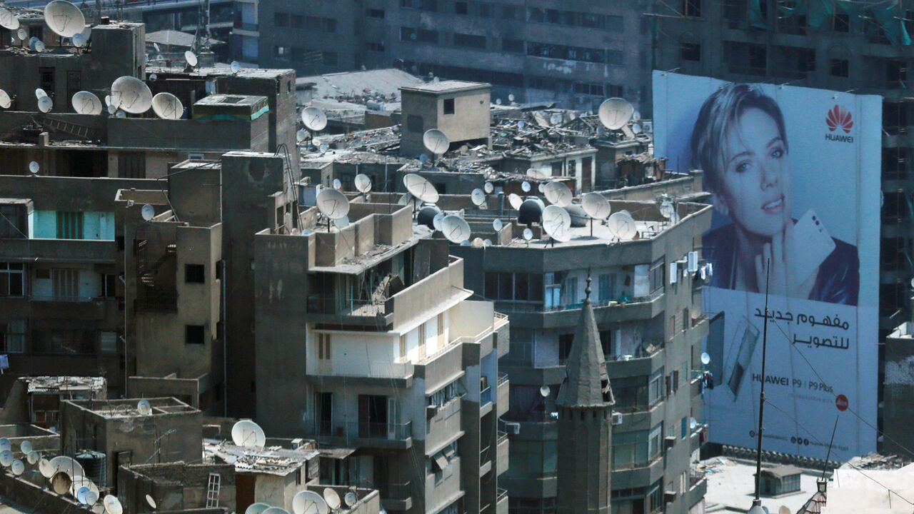 An advertise for Huawei mobile with American actress Scarlett Johansson is seen between old houses at the center of downtown Cairo, Egypt August 31, 2016. REUTERS/Amr Abdallah Dalsh - D1BETYPANEAA