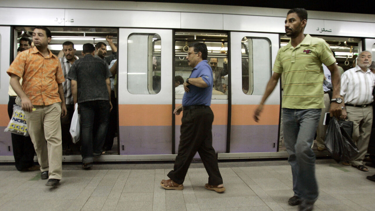 Passengers walk out of a train as new security measures are put in place on Cairo's underground Metro rail network July 18, 2007. Egypt has stepped up security on Cairo's underground Metro rail network over fears of a possible attack on its stations, a security source and a state-run newspaper said on Thursday. REUTERS/Nasser Nuri (EGYPT) - GM1DVSVJDKAA