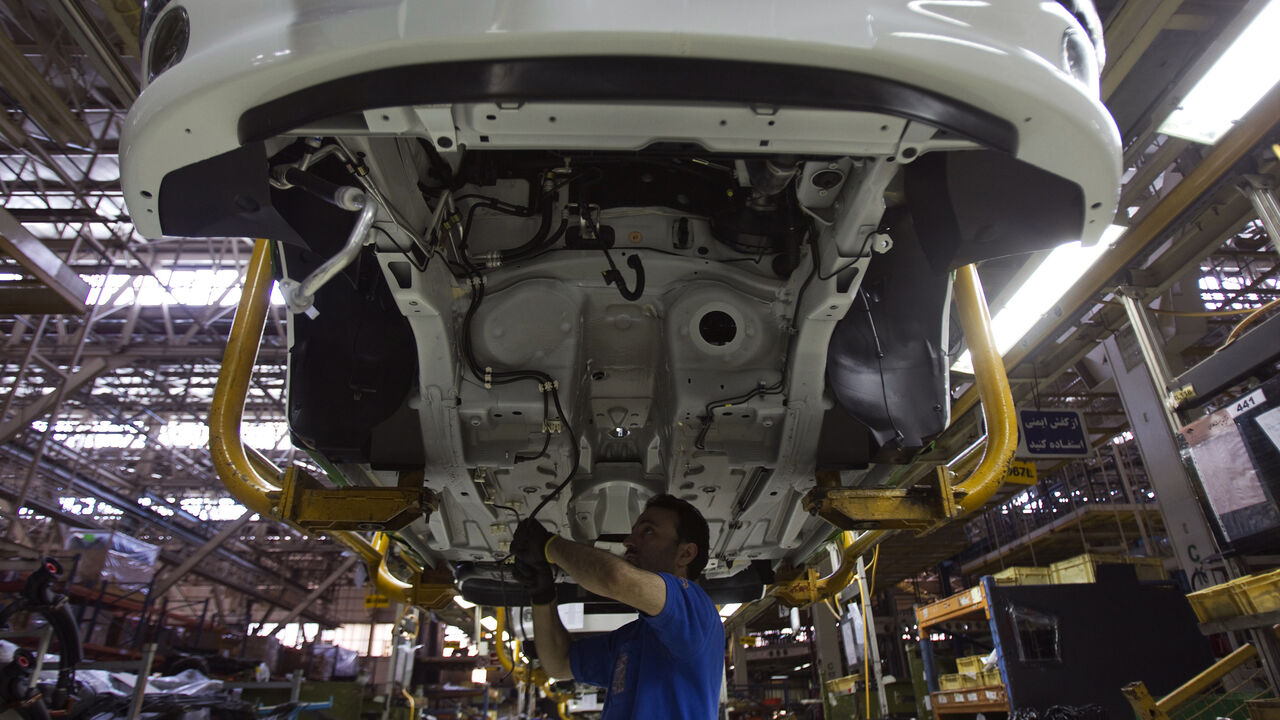 EDITORS' NOTE: Reuters and other foreign media are subject to Iranian restrictions on their ability to film or take pictures in Tehran. 
A worker assembles a vehicle at a production line of carmaker Iran Khodro, west of Tehran June 20, 2011. Iran Khodro, Iran's biggest car maker which runs what it says is the largest car factory in the Middle East, sees sales rising at home and abroad, despite economic sanctions on the Islamic Republic.  REUTERS/Morteza Nikoubazl (IRAN - Tags: TRANSPORT BUSINESS) - GM1E76K1