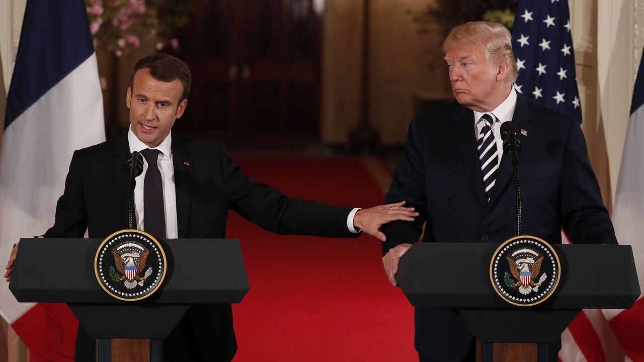 French President Emmanuel Macron reaches out to U.S. President Donald Trump as he speaks during their joint news conference at the White House in Washington, U.S., April 24, 2018. REUTERS/Jonathan Ernst - HP1EE4O1CL79F