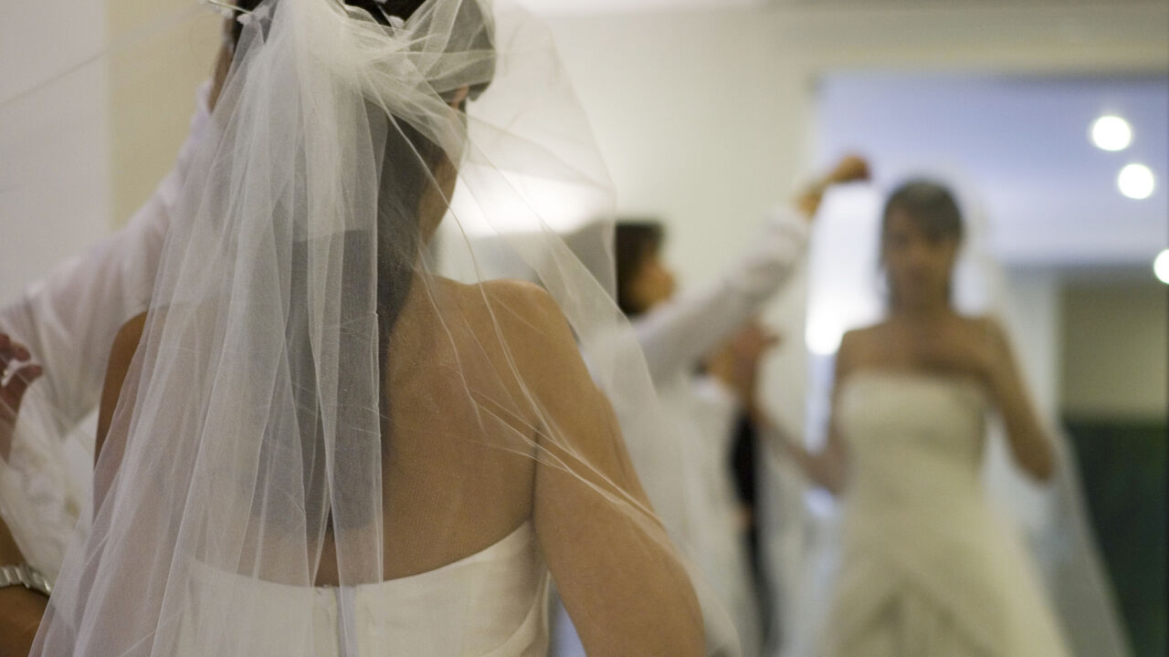 An Iranian dress designer checks the fit of a veil on a bride at a high fashion studio in north Tehran October 2, 2007. Wearing the all-enveloping chador (veil) or a headscarf and loose-fitting full-length coat is obligatory under Sharia law, imposed after the 1979 Islamic revolution. Offenders face fines, whipping or jail. But that has not stopped image-conscious Iranian women and a growing number are going under the knife for new noses, tummy tucks, liposuction, lifting eyelids or breast augmentation. Pic