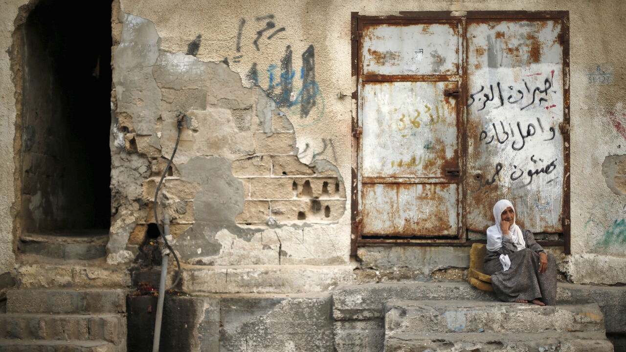A Palestinian woman sits outside her house as she escapes the heat during a power cut at Shatti (beach) refugee camp in Gaza City September 15, 2015. Power has been provided to different areas in the impoverished coastal territory in six-hour shifts as Gaza's lone power plant shut its generators on Saturday due to a fuel shortage, energy officials said. Electricity is also supplied to the Gaza grid through power lines from Israel and Egypt. Gaza's plant provides electricity to two-thirds of its population. 