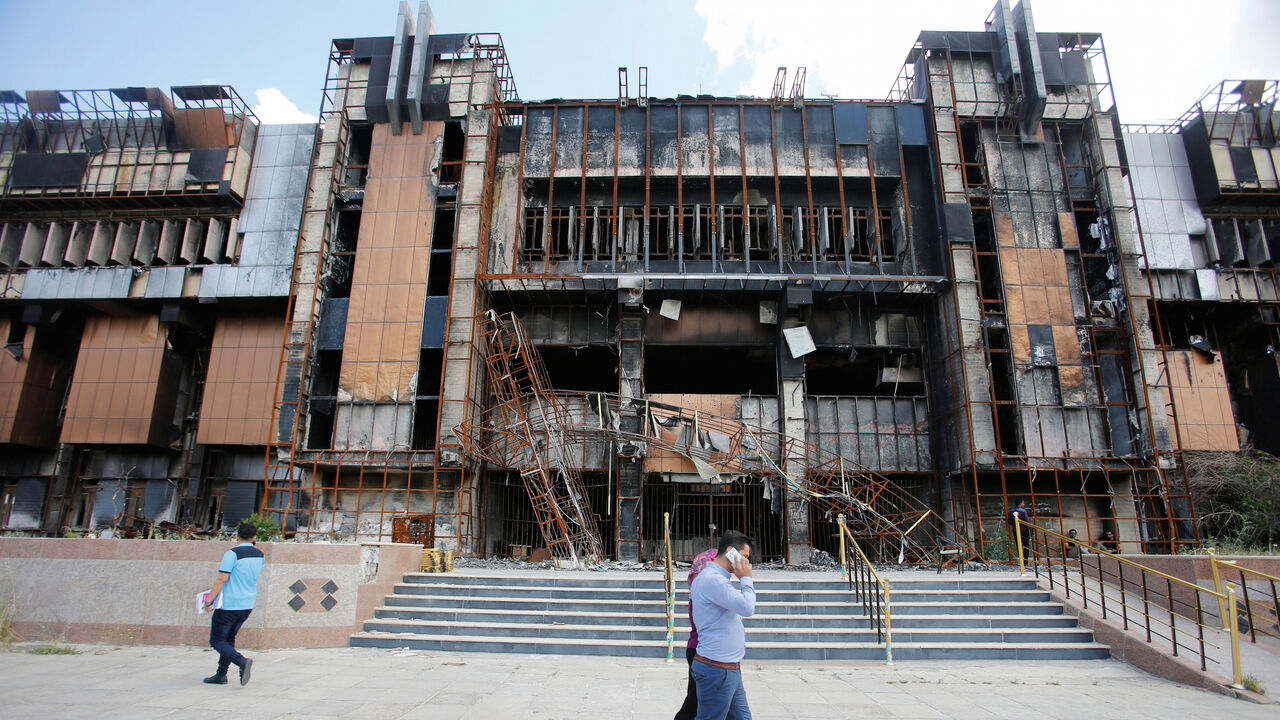 Iraqi students walk near a building of the central Library of the University of Mosul, in Mosul, Iraq May 14, 2018. Picture taken May 14, 2018.  REUTERS/Khalid Al-Mousily - RC1B179A97E0