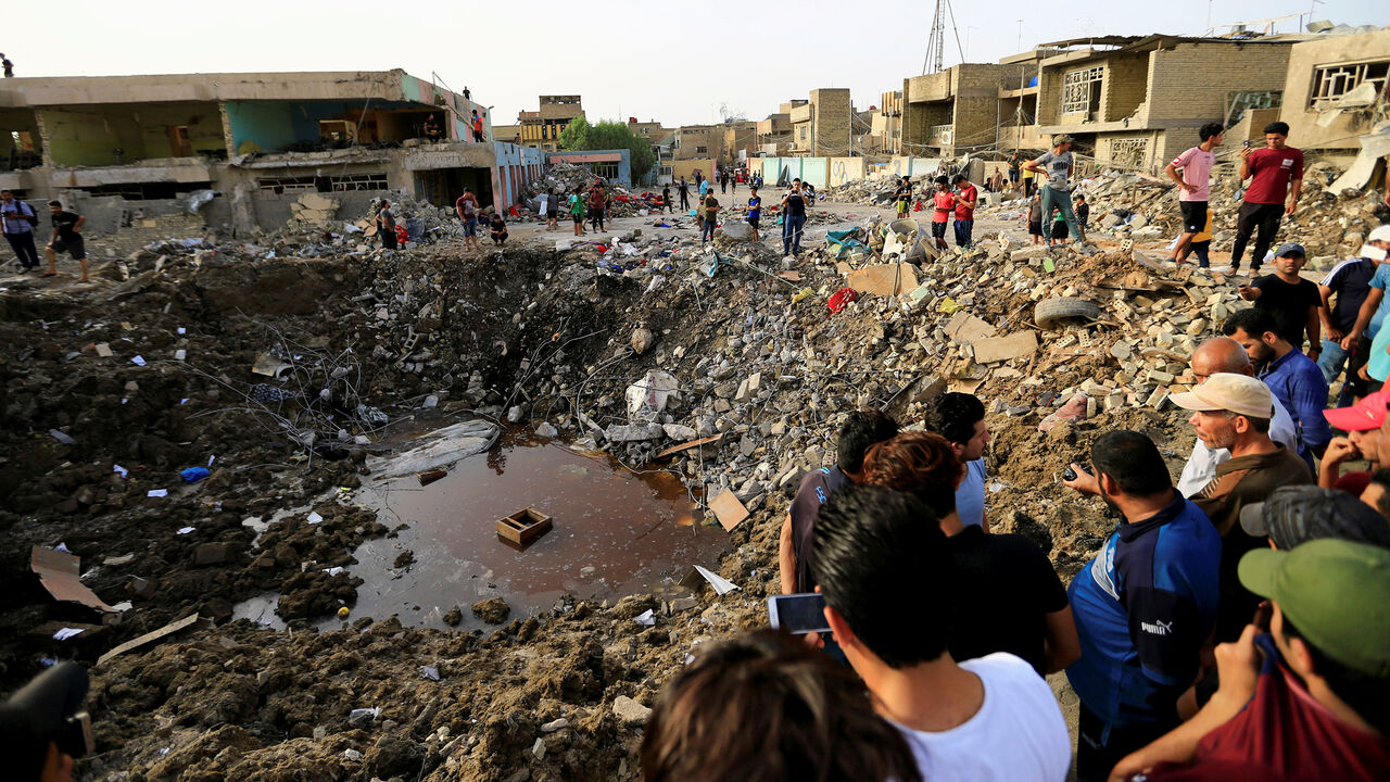 People gather at the site of an explosion in Baghdad's Sadr City district, Iraq June 7, 2018. REUTERS/Thaier Al-Sudani     TPX IMAGES OF THE DAY - RC182A806690