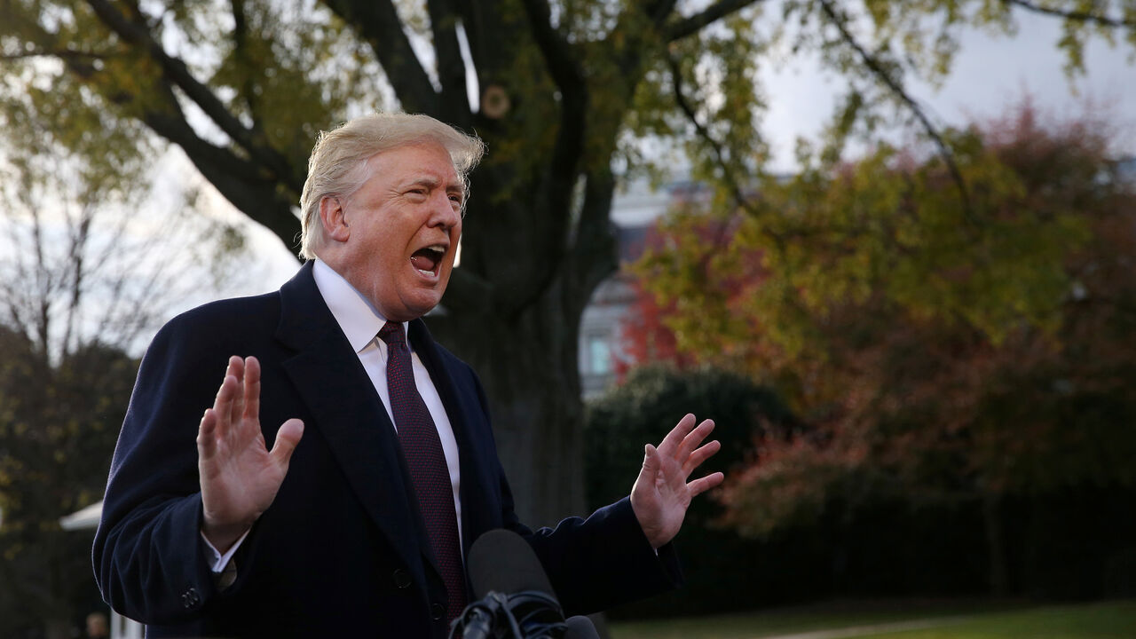 U.S. President Donald Trump speaks to the news media while walking to board Marine One to depart for travel to Mar-a-Lago from the White House in Washington, U.S., November 20, 2018. REUTERS/Leah Millis - RC19D819FF30
