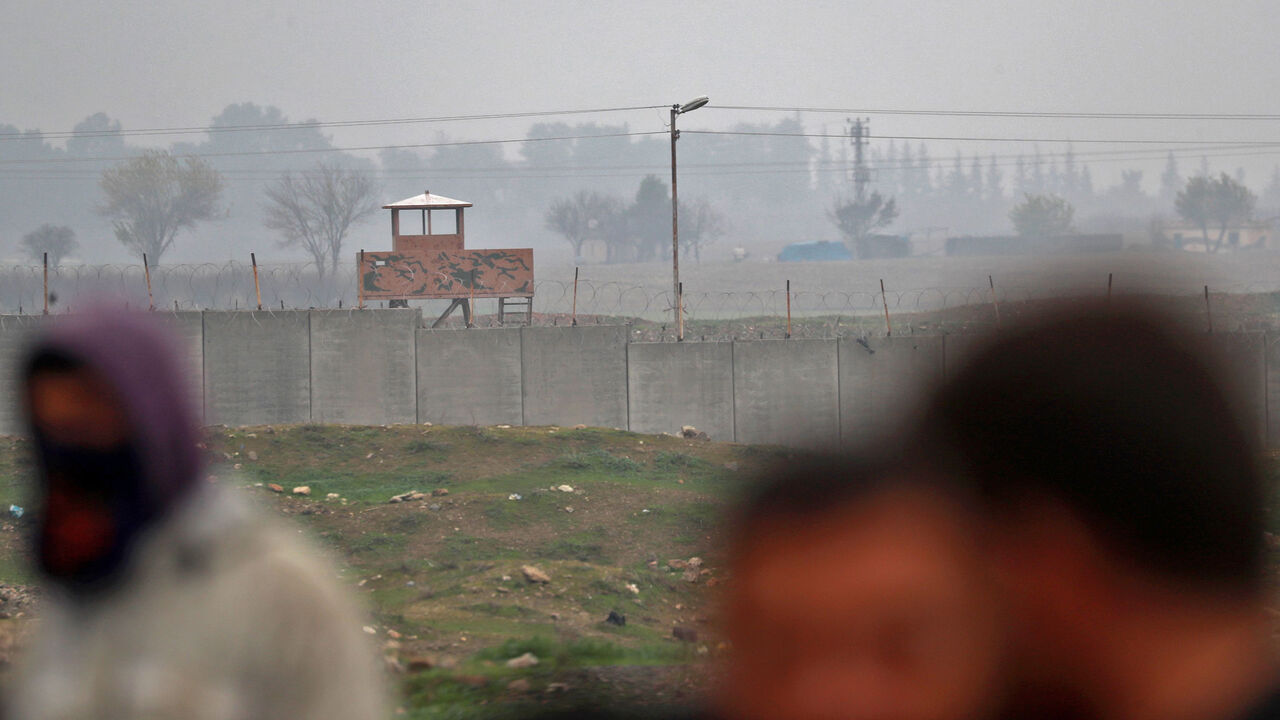 Turkish observation posts are seen on the Turkish side as Kurdish protesters gather to protest near the border wall separating Turkey from Syria in the western Syrian countryside of Ras al-Ain on December 20, 2018. - Syrian Kurdish forces said they will keep fighting the Islamic State group in eastern Syria unless they come under Turkish attack, after their US allies announced their withdrawal. (Photo by Delil souleiman / AFP)        (Photo credit should read DELIL SOULEIMAN/AFP/Getty Images)