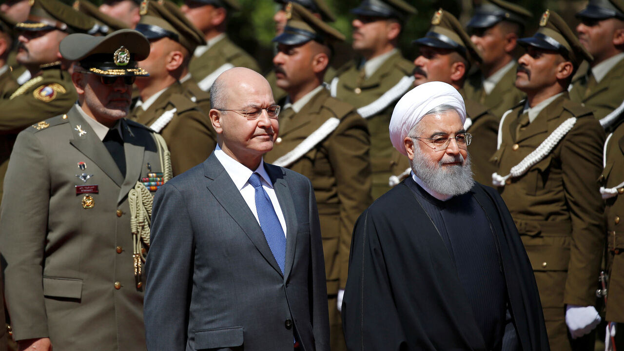Iraq's President Barham Salih walks with Iranian President Hassan Rouhani during a welcome ceremony at Salam Palace in Baghdad, Iraq March 11, 2019. REUTERS/Thaier al-Sudani - RC1EE48851F0