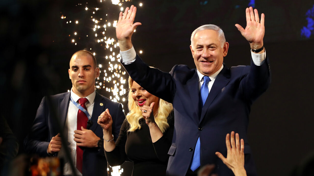 Israeli Prime Minister Benjamin Netanyahu and his wife Sara react as they stand on stage following the announcement of exit polls in Israel's parliamentary election at the party headquarters in Tel Aviv, Israel April 10, 2019. REUTERS/Ammar Awad - RC195587B720