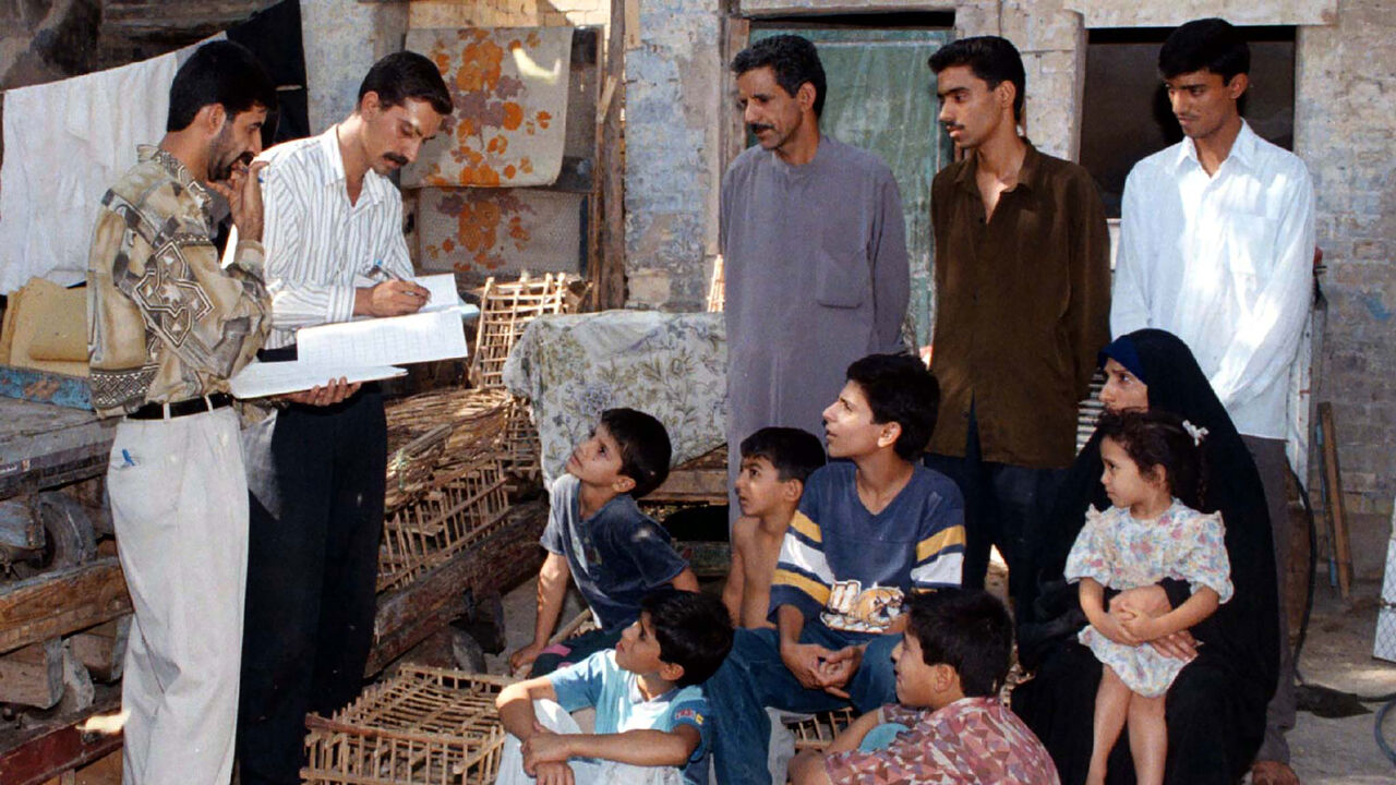 An Iraqi family listen to questions asked them by government officials conducting the country's official census, October 16. Iraqis stayed at home on Thursday as the country conducted its first census for 10 years, the first since the imposition of sanctions by the United Nations following Iraq's invasion of -Kuwait and the subsequent Gulf-War. - PBEAHUMQHCP
