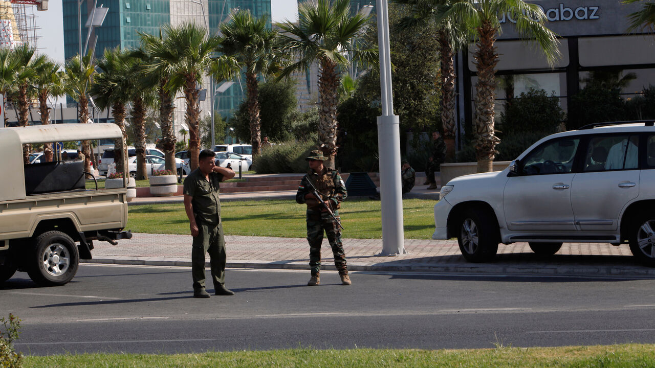 Kurdish security members stand guard near a restaurant where Turkish diplomats and Turkish consulate employee were killed in Erbil, Iraq July 17, 2019.  REUTERS/Azad Lashkari - RC15FE0B8D60