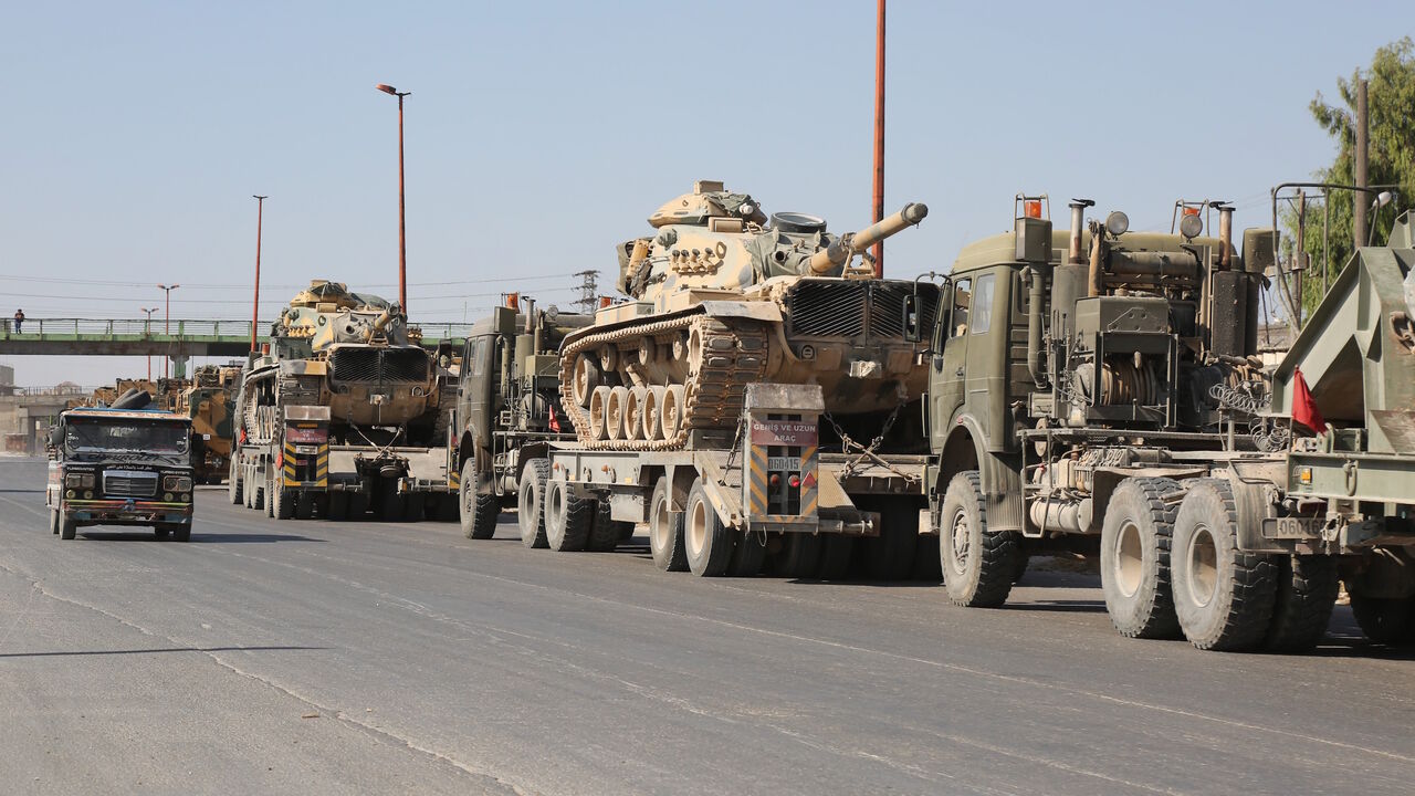 IDLIB, SYRIA - AUGUST 19: Turkish military convoy is seen on August 19, 2019 in Syria's northern province of Idlib. Syrian regime launches airstrikes on Maarat Al-Numan town as a convoy of Turkish military vehicles passes through the town. An airstrike killed three civilians and injured 12 others during a transfer to Turkeys observation point in Syrias Idlib. 
 (Photo by Izzettin Idilbi/Anadolu Agency via Getty Images)