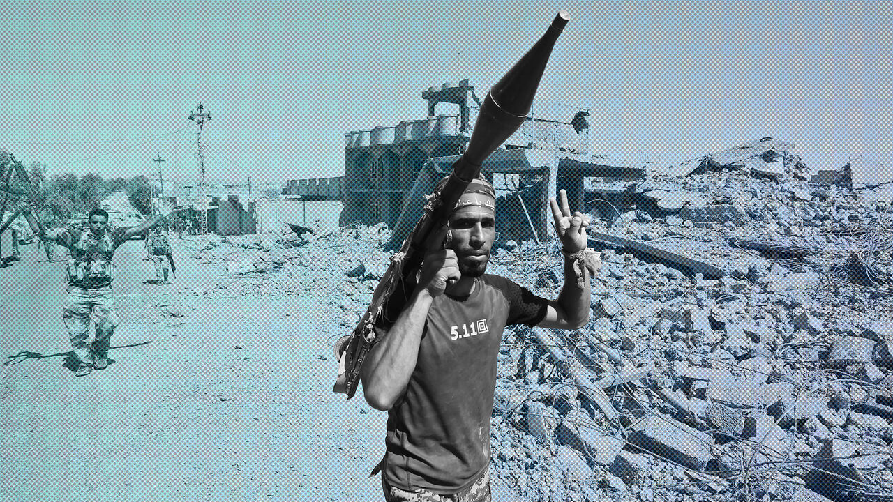 TOPSHOT - A fighter of the Hashed Al-Shaabi (Popular Mobilization units) flashes the victory gesture while carrying a rocket-propelled grenade (RPG) launcher during the advance through the town of Tal Afar, west of Mosul, after the Iraqi government announced the launch of the operation to retake it from Islamic State (IS) group control, on August 26, 2017. / AFP PHOTO / AHMAD AL-RUBAYE        (Photo credit should read AHMAD AL-RUBAYE/AFP/Getty Images)