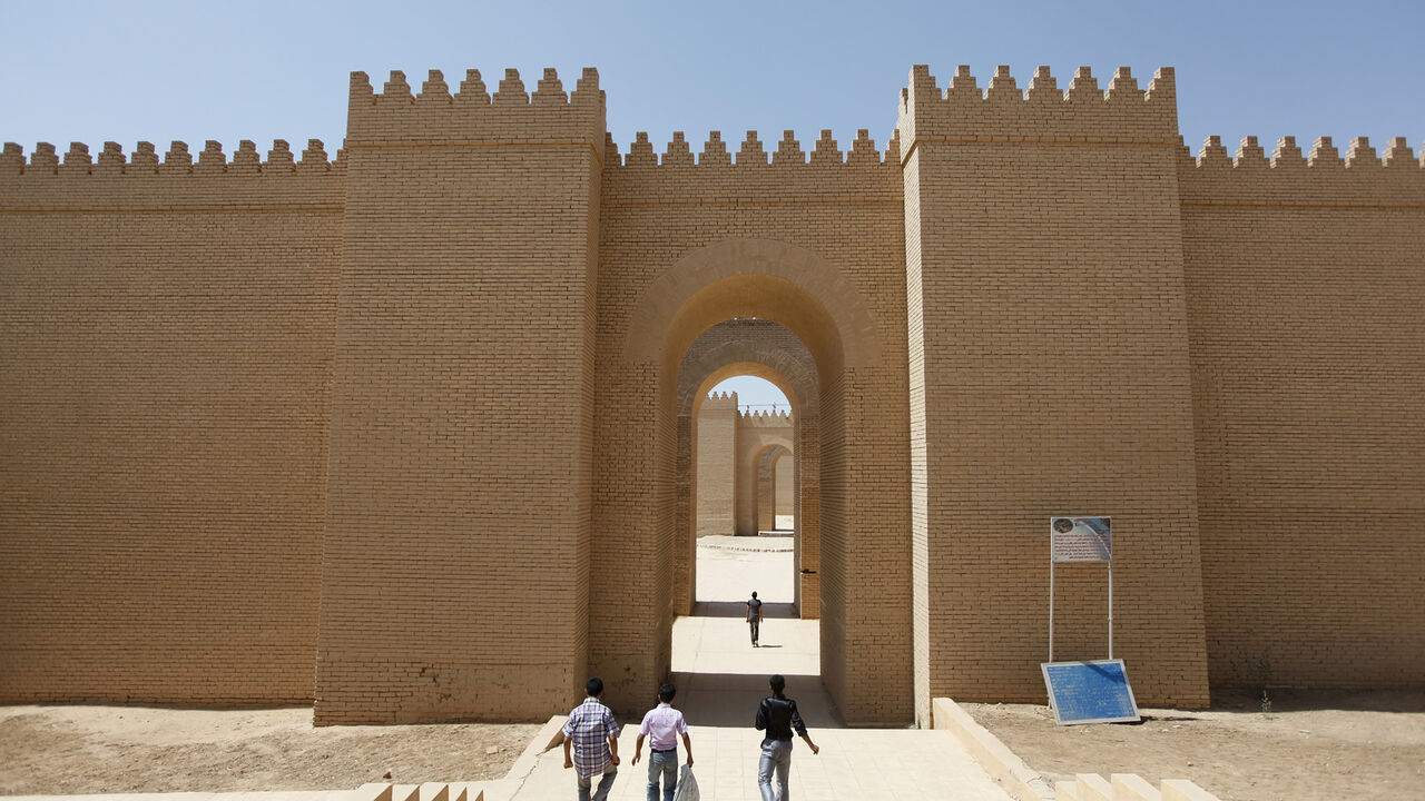 Visitors enter the ancient city of Babylon near Hilla, 100 km (62 miles) south of Baghdad April 5, 2012. In the ancient city of Babylon, once home to the fabled Hanging Gardens, an extended oil pipeline has churned through the dirt and dug up a conundrum: which takes precedence, preserving Iraq's heritage or developing its oil wealth? The definitive answer will probably be decades coming. But for the moment, oil appears to have the edge. The site of ancient Mesopotamia, said by some to be the birthplace of 