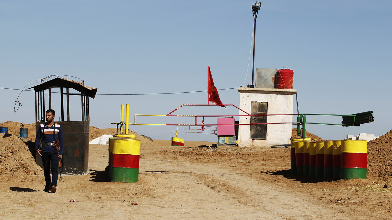 An officer of the Syrian Kurdish Democratic Union Party (PYD) stands guard near the Syrian-Iraq border October 31, 2012. Iraqi Kurdish President Masoud Barzani warned Kurds in Syria against being sucked into the "fires of discord," urging them to preserve Kurdish unity as tensions between rival factions threaten to spillover into violence. Syria's Kurds see the war ravaging their country as an unprecedented opportunity to gain the kind of freedoms enjoyed by their ethnic kin in neighbouring Iraq, where they
