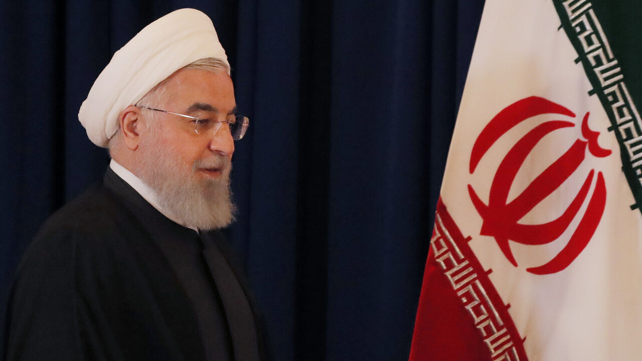 Iran's President Hassan Rouhani walks by his country's flag at a news conference on the sidelines of the 73rd session of the United Nations General Assembly at U.N. headquarters in New York, U.S., September 26, 2018. REUTERS/Brendan Mcdermid - HP1EE9Q1DYAGU