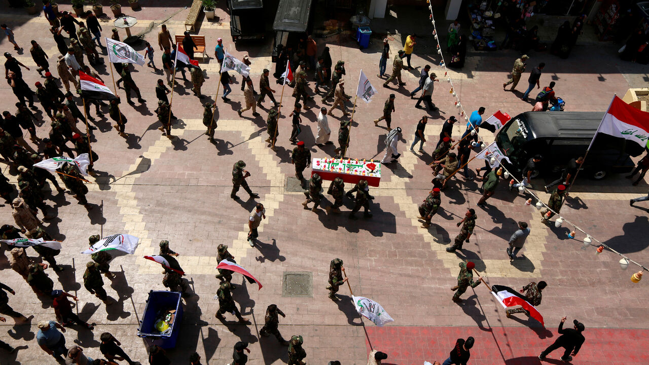 Members of the Popular Mobilisation Forces (MPF) carry the coffin of a fighter, who was killed by an unmanned aircraft close to the Syrian border in Anbar, during his funeral in Najaf, Iraq August 26, 2019. REUTERS/Alaa al-Marjani - RC15DE813700