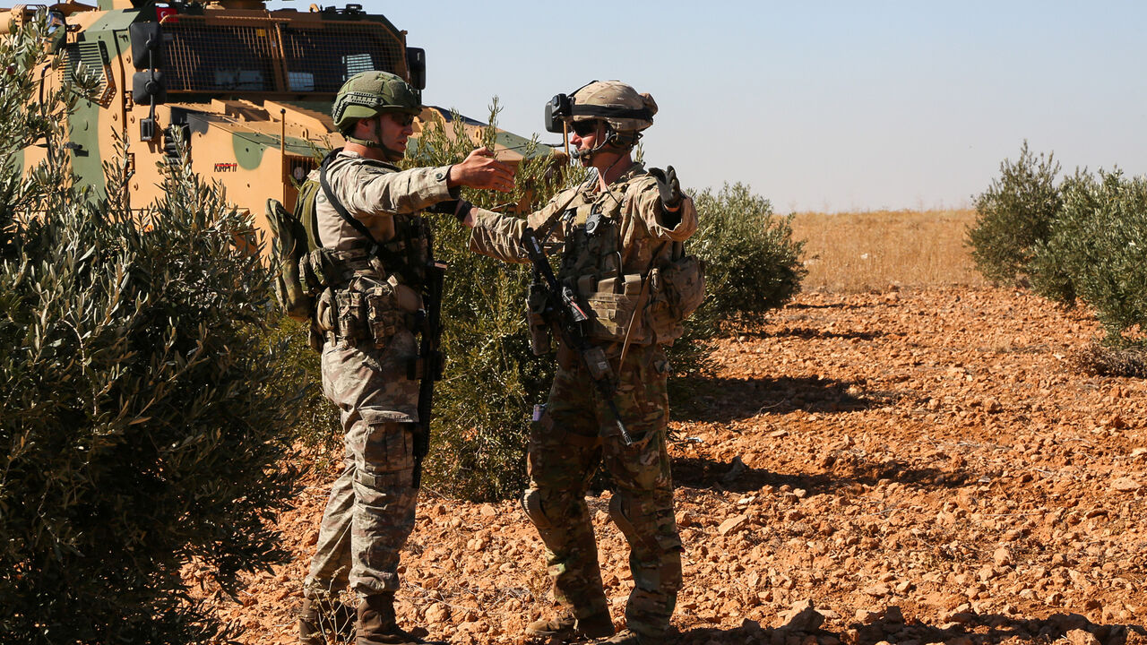 U.S. and Turkish soldiers discuss details during the first-ever combined joint patrol in Manbij, Syria, November 1, 2018. Picture taken November 1, 2018. Courtesy Arnada Jones/U.S. Army/Handout via REUTERS  ATTENTION EDITORS - THIS IMAGE HAS BEEN SUPPLIED BY A THIRD PARTY. - RC1659329F10
