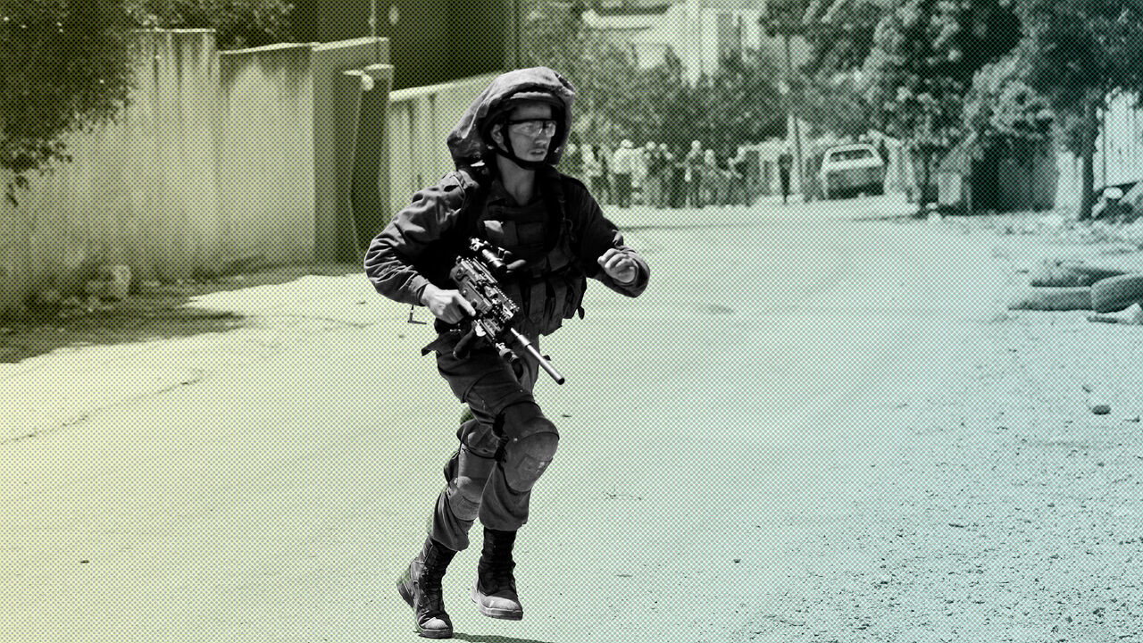 An Israeli soldier runs during a Palestinian protest against the nearby Jewish settlement of Qadomem, in the village of Kofr Qadom in the Israeli-occupied West Bank August 9, 2019. REUTERS/Mohamad Torokman - RC11D692AFE0