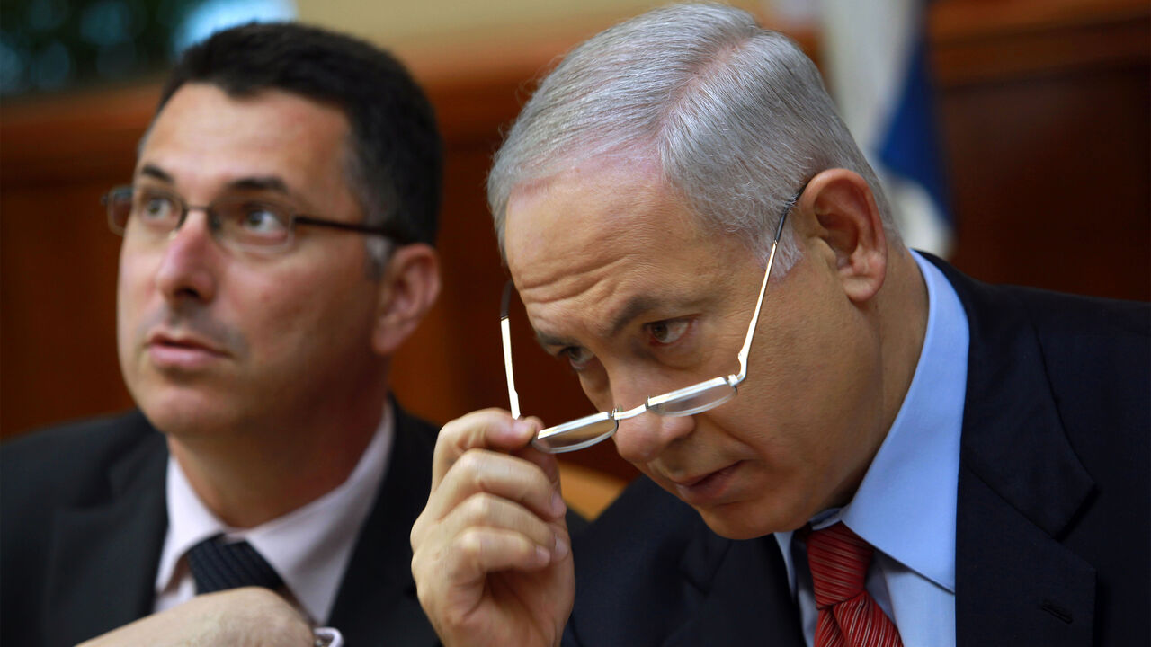 JERUSALEM, ISRAEL - OCTOBER 18: Israeli Prime Minister Benjamin Netanyahu looks over his glasses as he and Education Minister Gidon Sa'ar chat at the start of the weekly cabinet meeting October 18, 2009 in Jerusalem. The cabinet have rejected a UN Human Rights Council endorsement of the Goldstone report on the Israeli campaign in Gaza as unacceptable. (Photo by David Silverman/Getty Images)