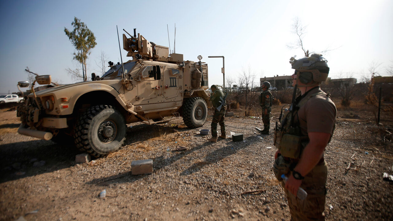 U.S. military vehicles are seen in the town of Bashiqa, east of Mosul, during an operation to attack Islamic State militants in Mosul, Iraq, November 7, 2016. REUTERS/Azad Lashkari - S1AEULMKDCAB