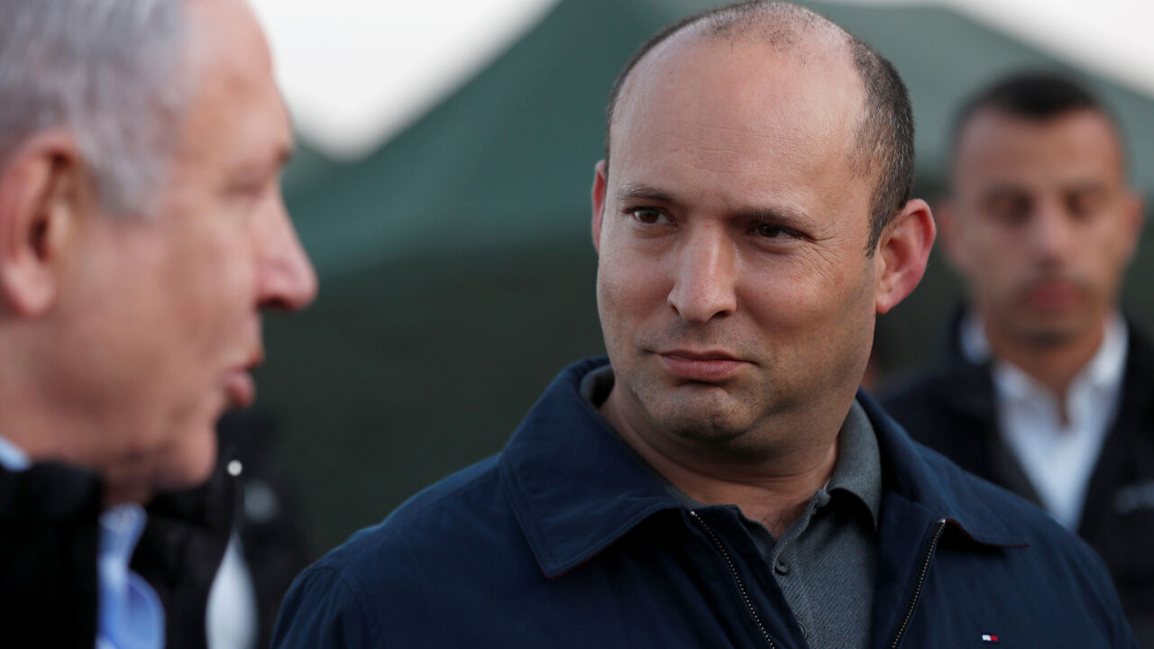 Israeli Defense Minister Naftali Bennett looks at Prime Minister Benjamin Netanyahu during a visit to an Israeli army base in the Israeli-occupied Golan Heights, November 24, 2019. Atef Safadi/Pool via REUTERS - RC2UHD9FXFTH