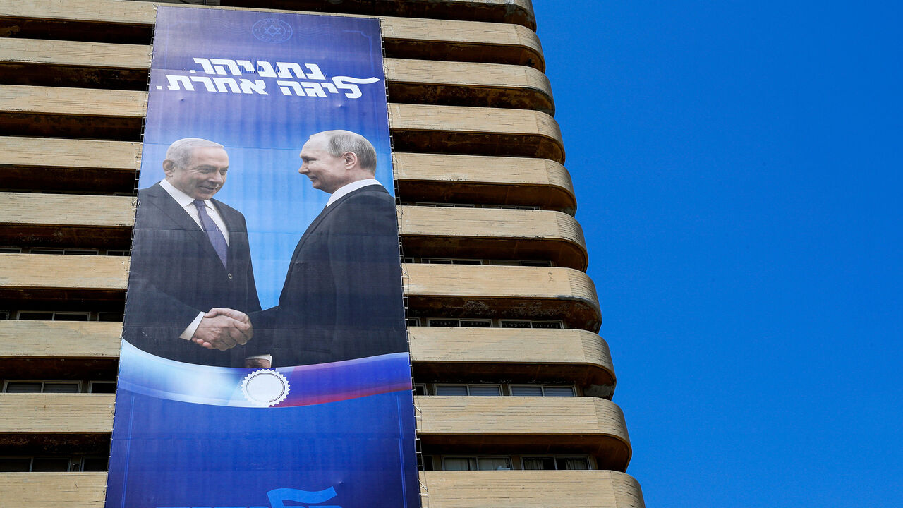 This picture taken on July 28, 2019 shows two giant Israeli Likud Party election banners hanging from a building showing Israeli Prime Minister Benjamin Netanyahu shaking hands with Russian President Vladimir Putin, with a caption above reading in Hebrew "Netanyahu, in another league", in the coastal Mediterranean city of Tel Aviv. (Photo by JACK GUEZ / AFP)        (Photo credit should read JACK GUEZ/AFP via Getty Images)