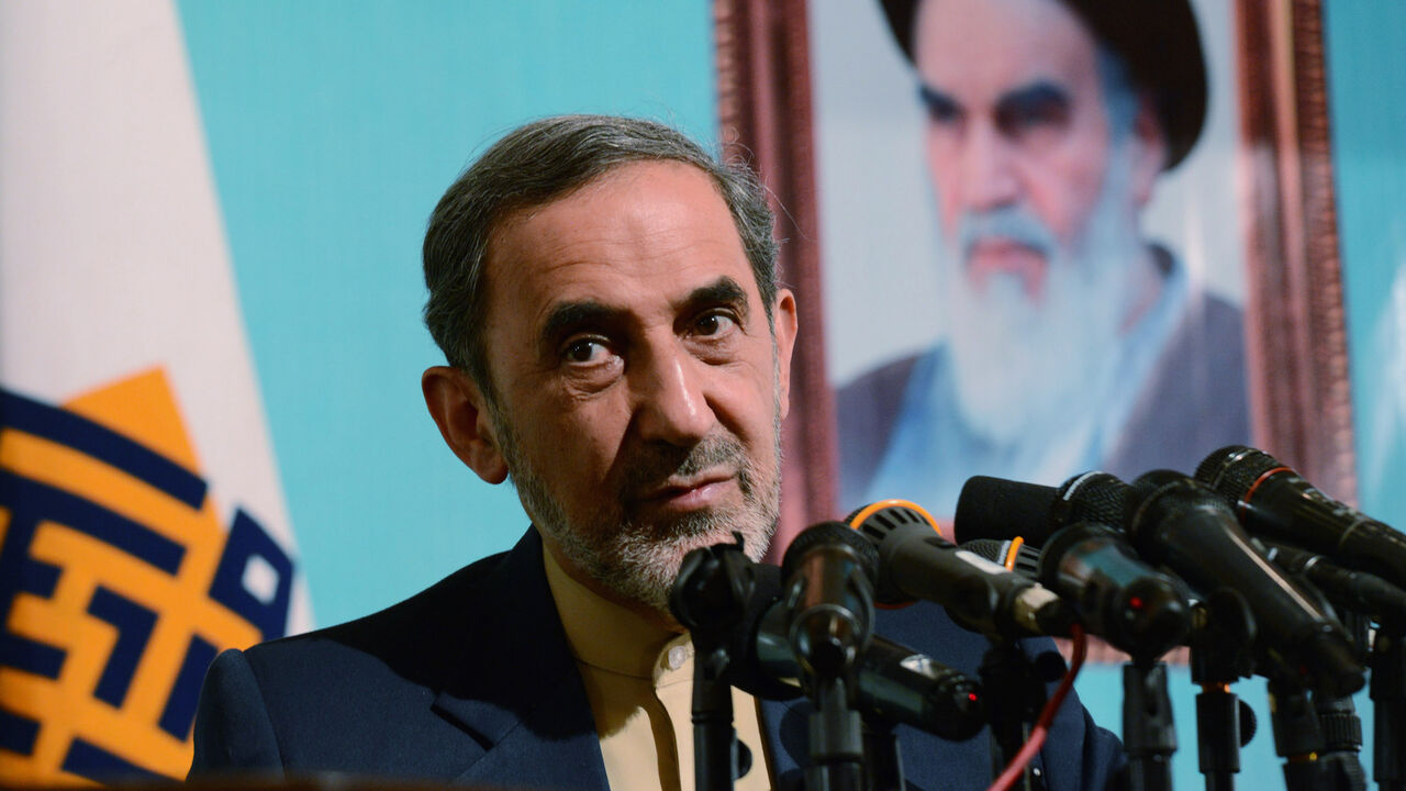 TEHRAN, IRAN - MAY 23, 2013: Under the picture of Ayatollah Khomeini the former foreign minister of Iran and a special adviser to the supreme leader Ayatollah Ali Khamenei, one of the favorite principalist presidential candidates in 2013 race, Dr. Ali Akbar Velayati speaks about his presidential agenda at Tehran university on May 23, 2013 in Tehran, Iran. He is one the the three candidates in 2+1 coalition. (Photo by Kaveh Kazemi/Getty Images)
