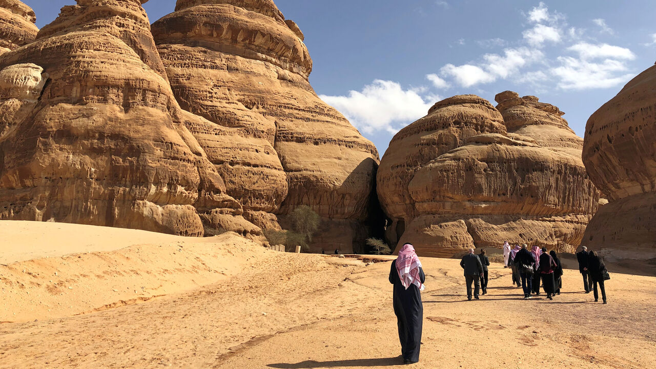 Visitors walk outside the tombs at the Madain Saleh antiquities site, al-Ula, Saudi Arabia February 10, 2019. Picture taken February 10, 2019.  REUTERS/Stephen Kalin - RC1F3C4632C0