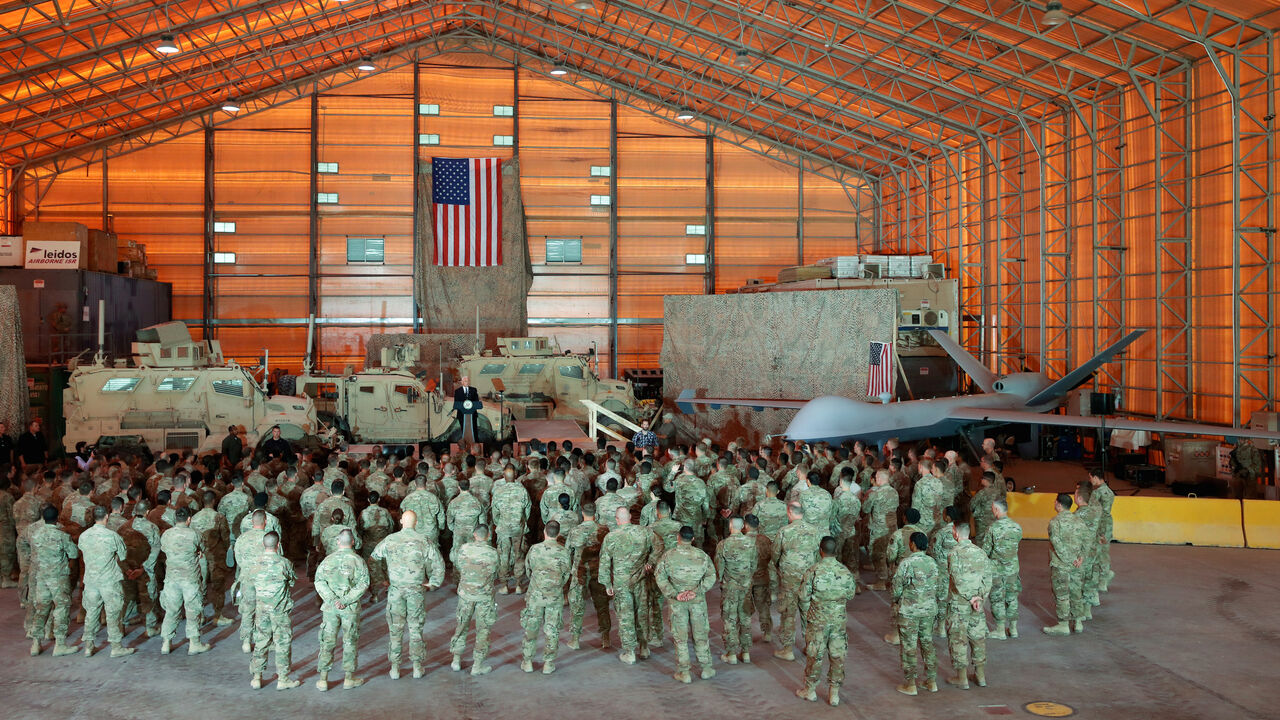 A drone and armored vehicles serve as a backdrop as U.S. Vice President Mike Pence delivers remarks to U.S. troops at Al Asad Air Base, Iraq November 23, 2019. REUTERS/Jonathan Ernst - RC29HD9HDU3K