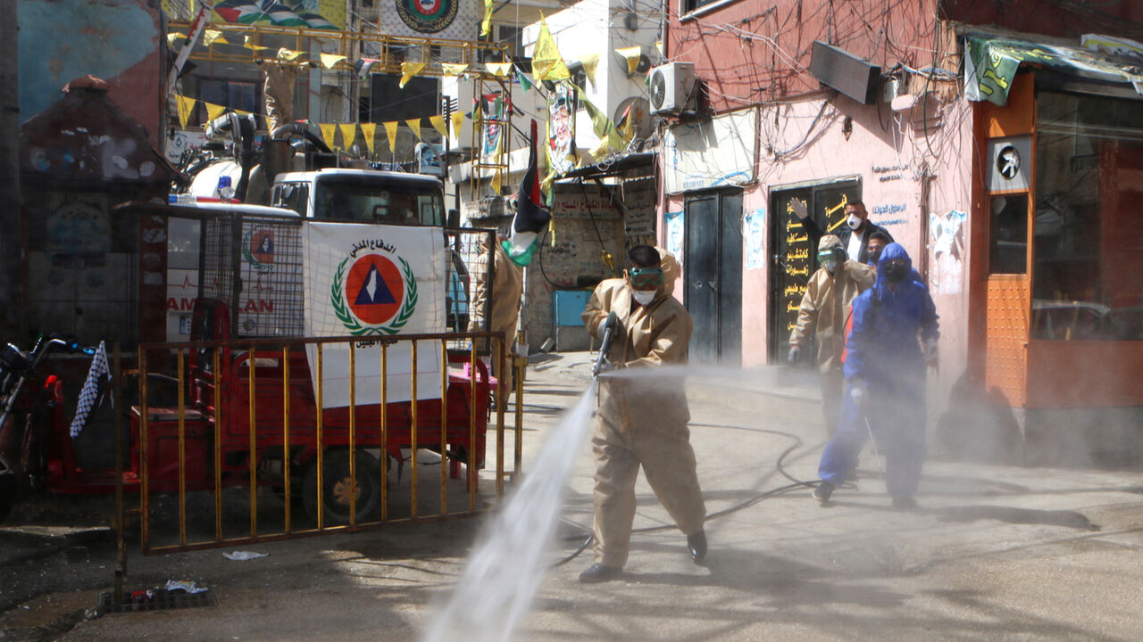 Workers disinfect the Wavel camp (also known as the Jalil Camp) for Palestinian refugees in Lebanon's eastern Bekaa Valley, on April 22, 2020, after the UN announced the first confirmed case of coronavirus there. - The patient, a Palestinian refugee from Syria, has been taken to the Lebanese state-run Rafiq Hariri hospital in Beirut, UNRWA, the UN agency for Palestinian refugees, said in a statement on April 21. More than 2,000 people live in Wavel, according to statistics released by Lebanons' government a